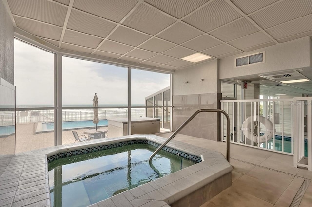 view of swimming pool featuring an indoor hot tub