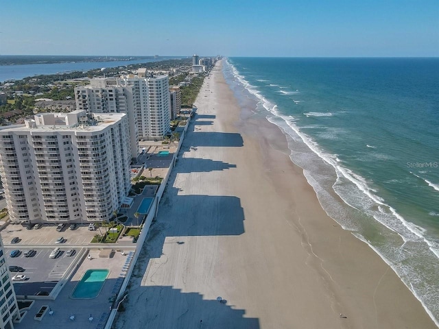 birds eye view of property featuring a water view and a view of the beach