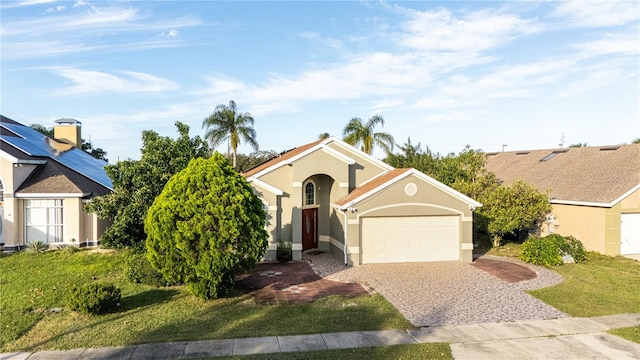 view of front of property with a front yard and a garage