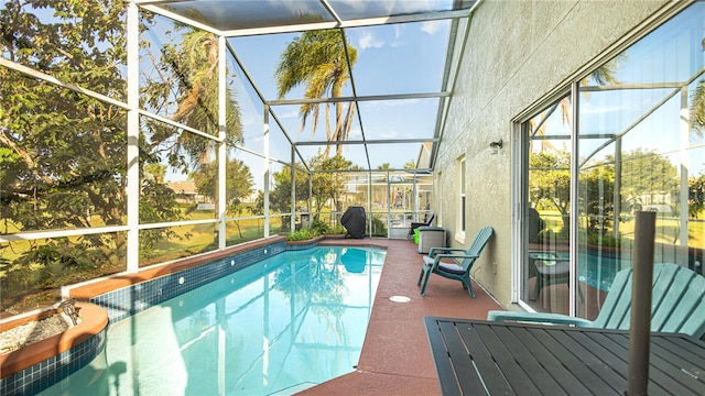 view of swimming pool with a patio area and glass enclosure