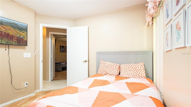 tiled bedroom with a textured ceiling