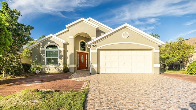 223 Lake Davenport Ests, Davenport, FL 33897 - mediterranean / spanish home with stucco siding, decorative driveway, and a garage