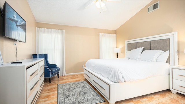 bedroom featuring light hardwood / wood-style flooring, ceiling fan, and vaulted ceiling