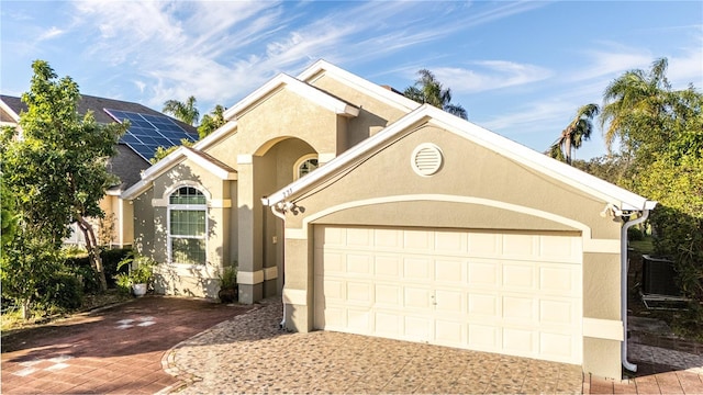 223 Lake Davenport Ests, Davenport, FL 33897 - view of front of home with decorative driveway, an attached garage, and stucco siding