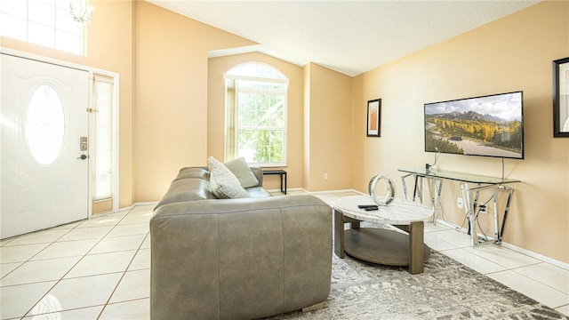 223 Lake Davenport Ests, Davenport, FL 33897 - living room with lofted ceiling, light tile patterned floors, and baseboards