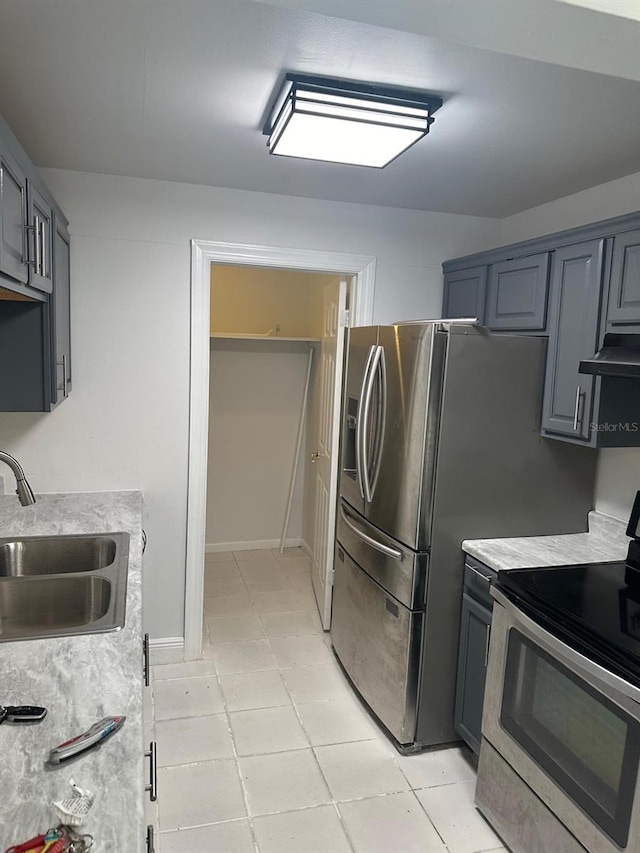 kitchen featuring ventilation hood, sink, stainless steel electric range oven, and light tile patterned floors