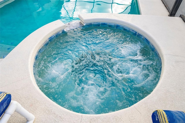 view of pool with an in ground hot tub