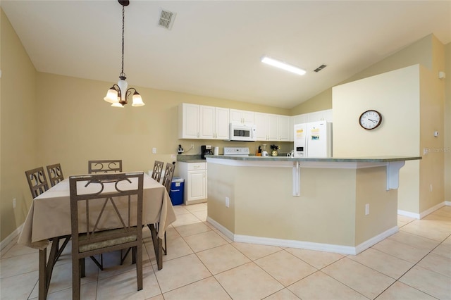 kitchen featuring pendant lighting, white appliances, white cabinetry, and vaulted ceiling