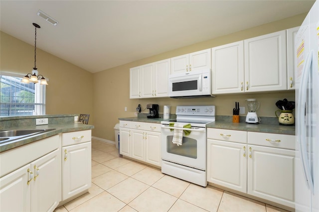 kitchen featuring white appliances, light tile patterned floors, a chandelier, white cabinetry, and hanging light fixtures