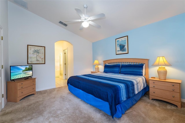 bedroom featuring ceiling fan, carpet floors, ensuite bathroom, and lofted ceiling