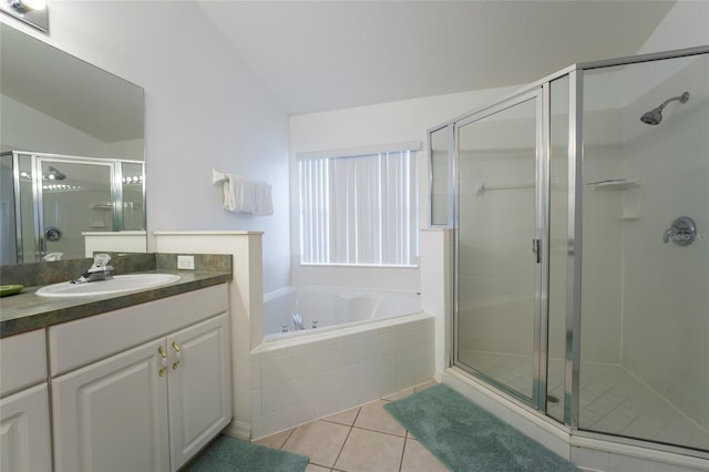 bathroom featuring vanity, separate shower and tub, lofted ceiling, and tile patterned floors