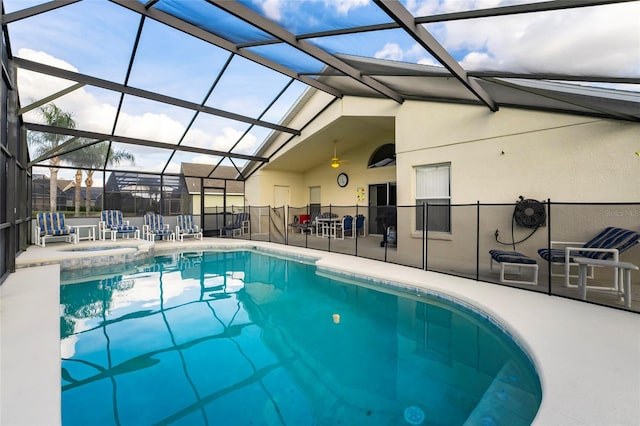 view of swimming pool with a patio area and a lanai