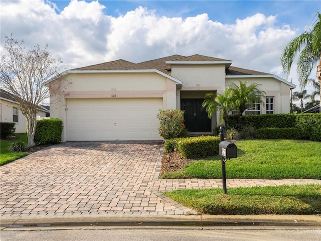 view of front of home with a front lawn and a garage