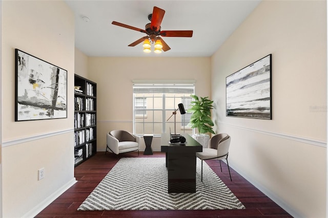 home office with ceiling fan and dark hardwood / wood-style flooring