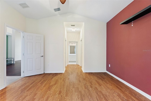 interior space with ceiling fan, lofted ceiling, and light hardwood / wood-style flooring