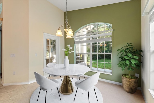 tiled dining area featuring a chandelier