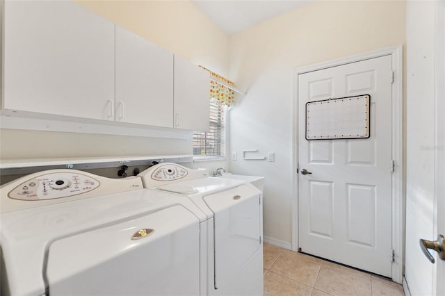 laundry room with sink, light tile patterned flooring, cabinets, and washing machine and clothes dryer