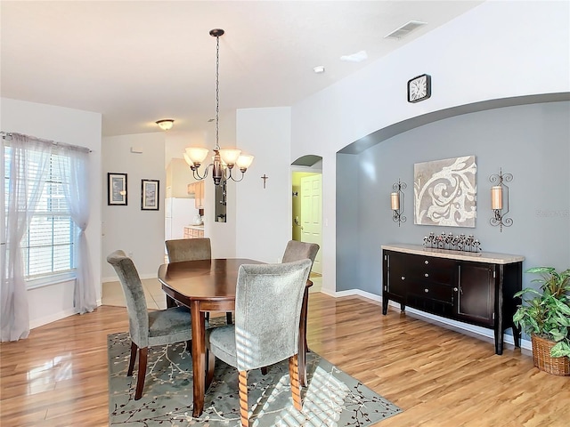 dining area with a chandelier and light wood-type flooring