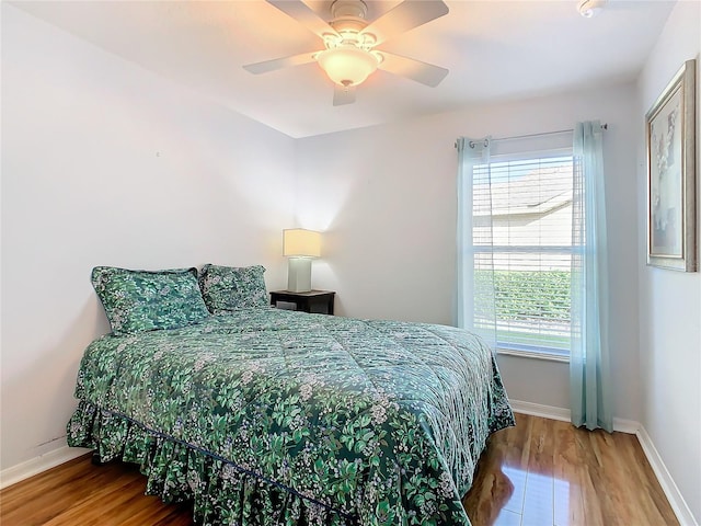 bedroom with hardwood / wood-style flooring and ceiling fan