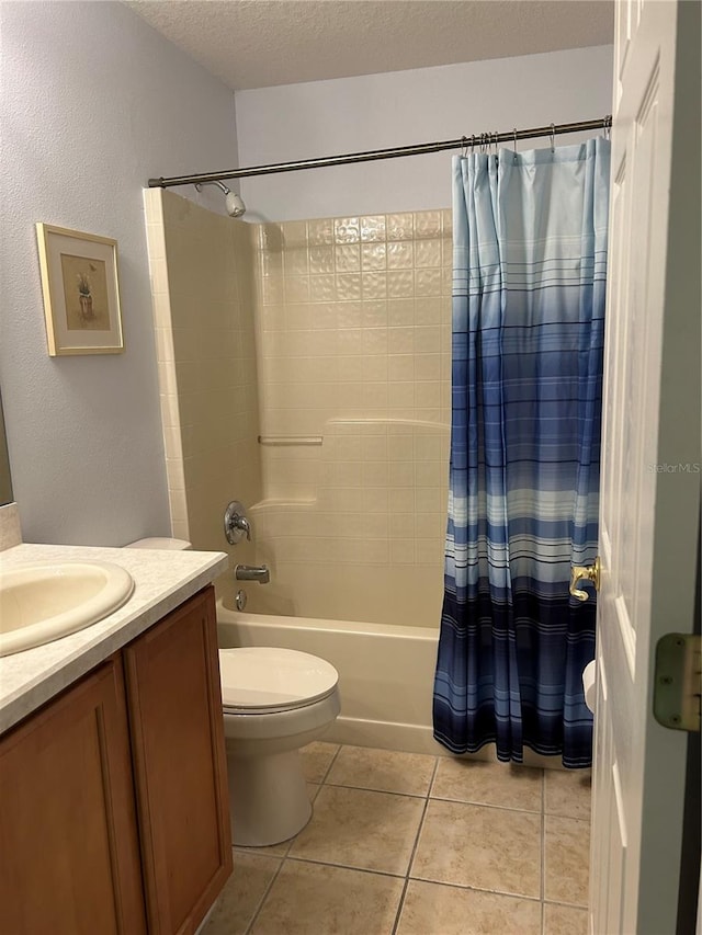 full bathroom with a textured ceiling, toilet, tile patterned floors, vanity, and shower / tub combo with curtain