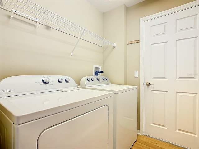 washroom featuring light hardwood / wood-style floors and separate washer and dryer