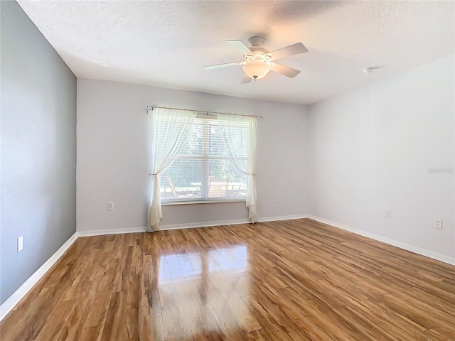 unfurnished room with a textured ceiling, hardwood / wood-style flooring, and ceiling fan