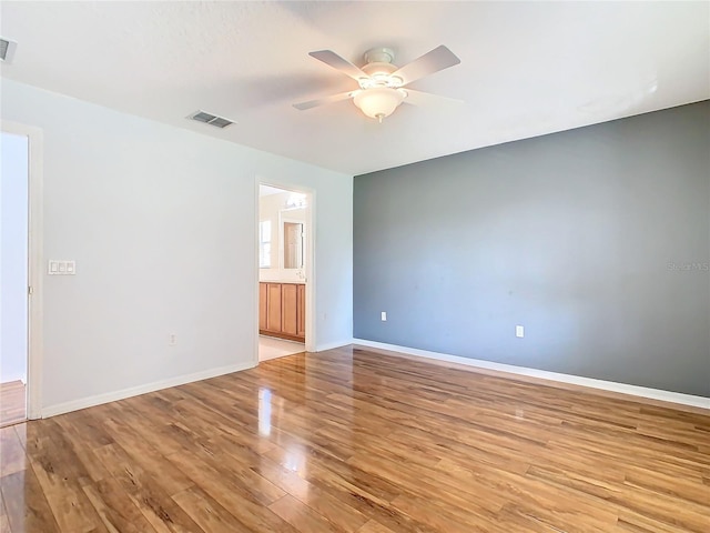 empty room with light hardwood / wood-style flooring and ceiling fan