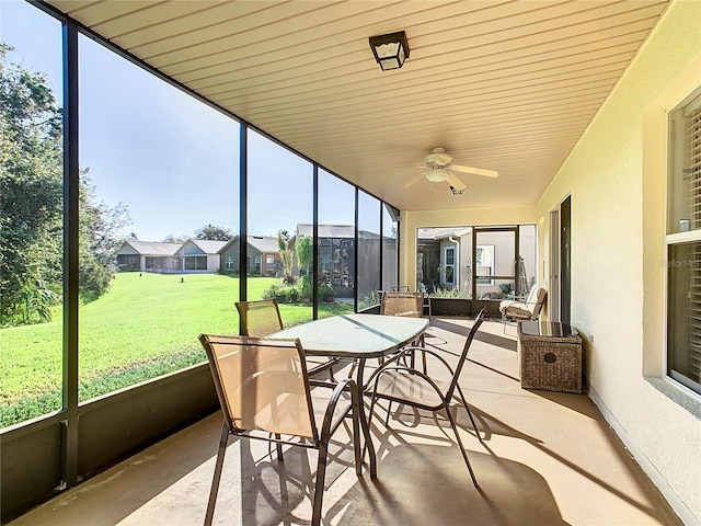 sunroom / solarium featuring ceiling fan