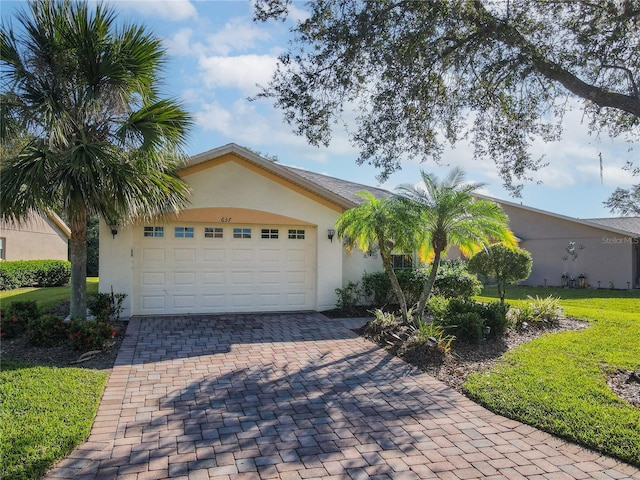 ranch-style home with a front yard and a garage