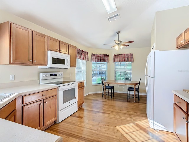 kitchen with white appliances, ceiling fan, and light hardwood / wood-style flooring