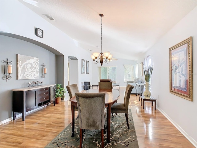 dining area featuring a notable chandelier and light wood-type flooring