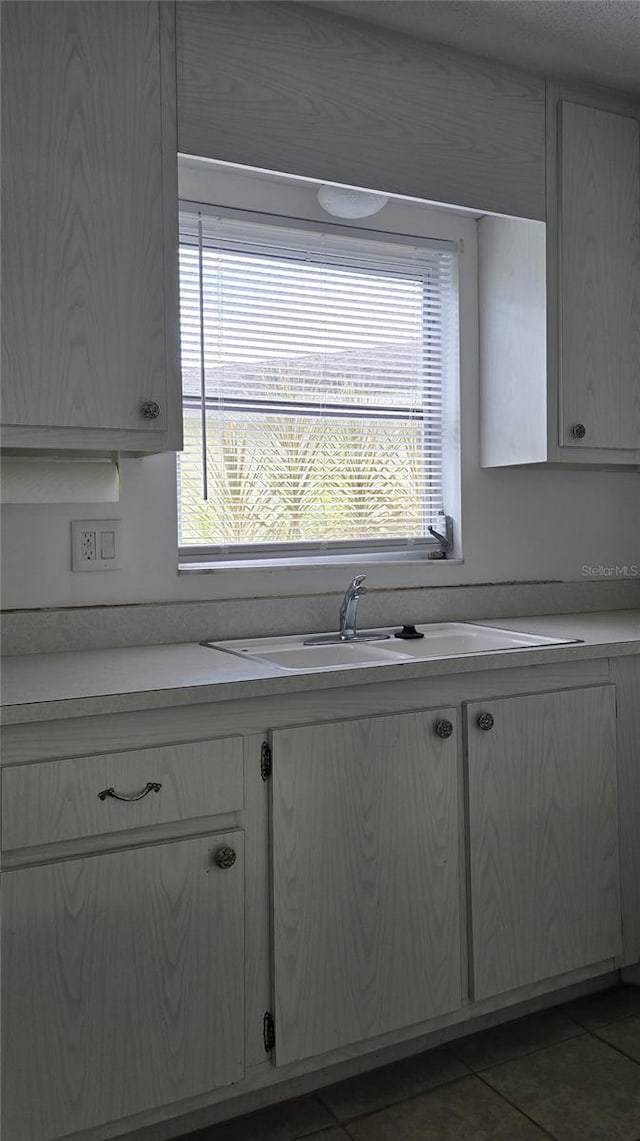 kitchen with tile patterned floors and sink