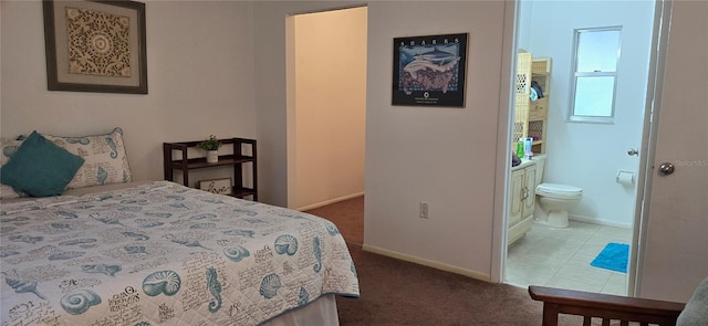 bedroom featuring connected bathroom and carpet flooring