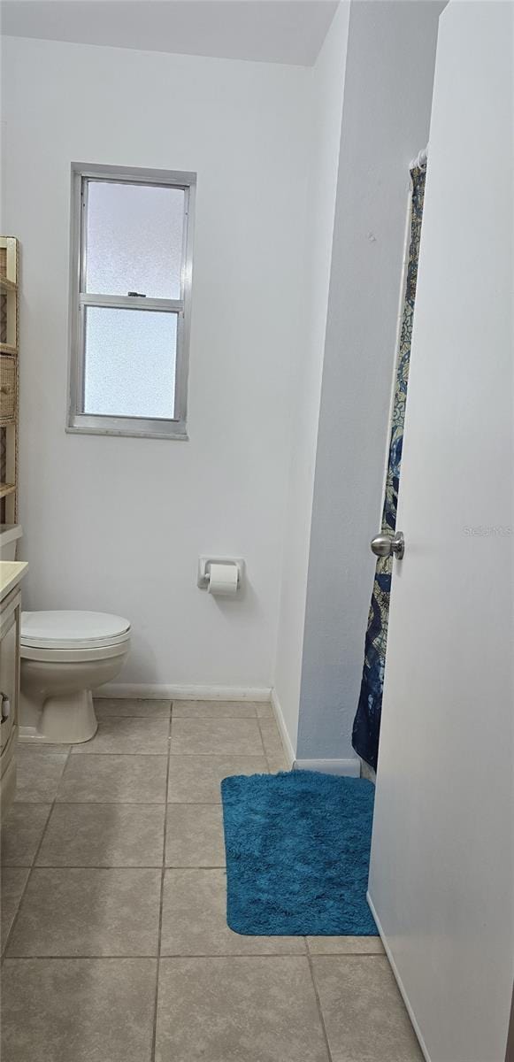 bathroom with vanity, toilet, and tile patterned flooring