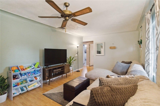 living room featuring ceiling fan and hardwood / wood-style floors