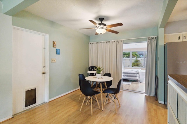 dining room featuring light hardwood / wood-style floors and ceiling fan