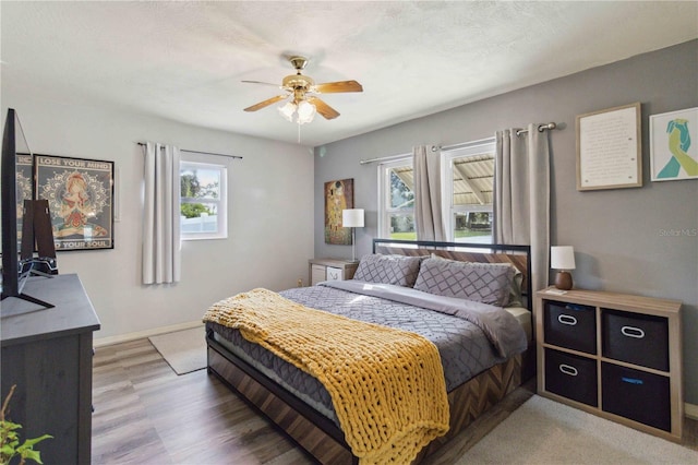 bedroom featuring hardwood / wood-style flooring and ceiling fan