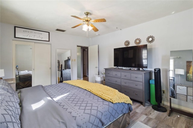 bedroom with light wood-type flooring and ceiling fan