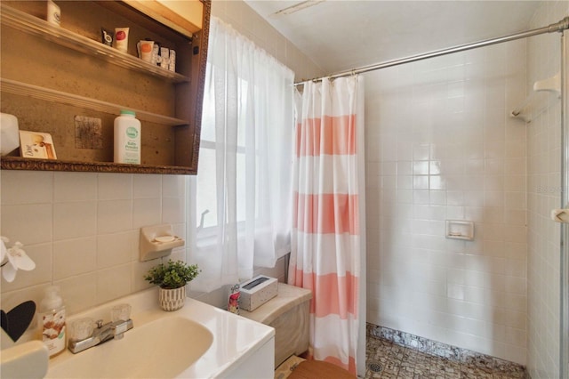 bathroom with vanity, a shower with curtain, and tile walls