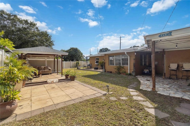 view of yard featuring a gazebo, fence, and a patio area