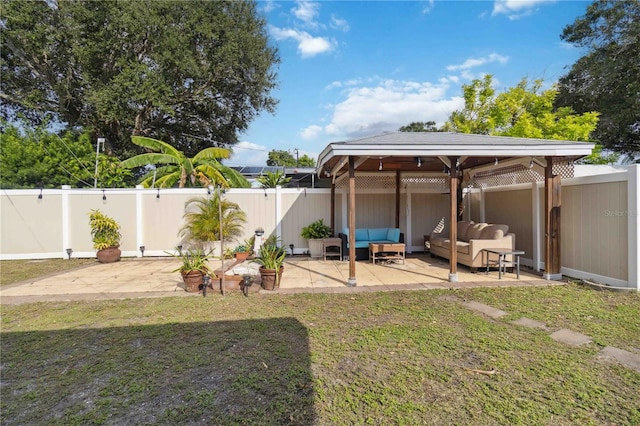 view of yard with a fenced backyard, a gazebo, an outdoor living space, and a patio area