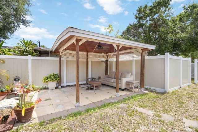 view of patio with a fenced backyard, a ceiling fan, and an outdoor hangout area