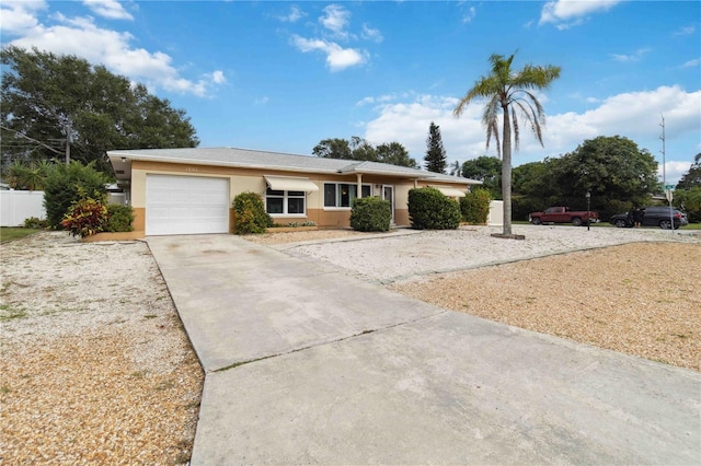 single story home featuring an attached garage, driveway, and stucco siding
