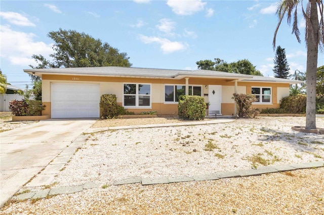 ranch-style house with stucco siding, driveway, and an attached garage