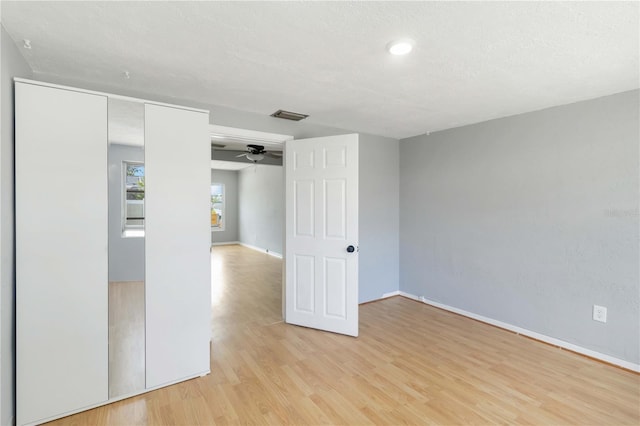 spare room with visible vents, baseboards, a ceiling fan, and light wood-style floors