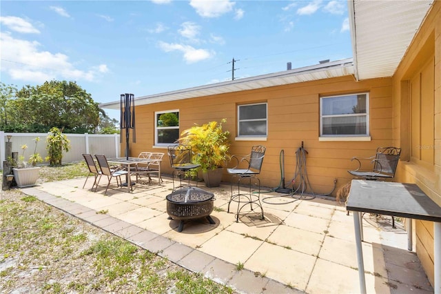 view of patio / terrace featuring a fire pit and fence