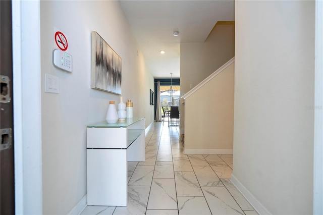 hallway featuring recessed lighting, stairs, marble finish floor, and baseboards