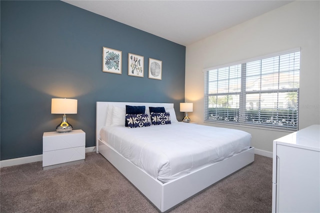 bedroom featuring baseboards and carpet