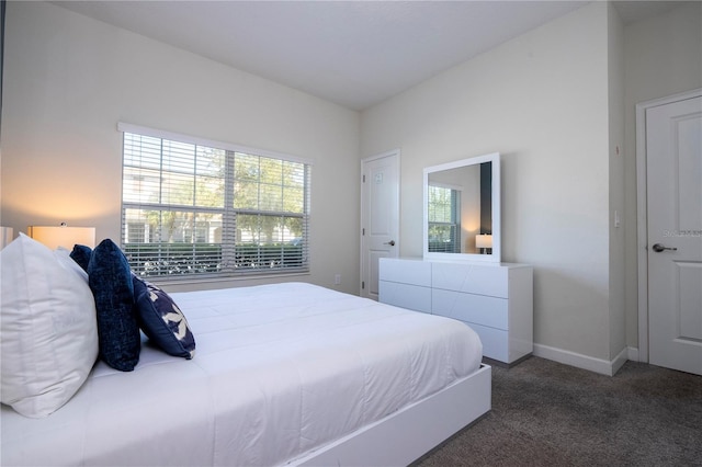 carpeted bedroom featuring baseboards