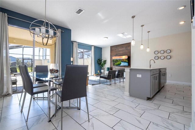 dining area with sink and a chandelier